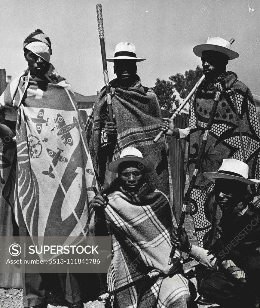 Stock Photo: 5513-111845786 Crime War - A Russian guard at the tunnel that goes under the railwayline dividing them from the Civil Guards. The blanket designs are traditionally Sotho (they are mostly Basutos from Basutoland) and so are the white panama hats and sticks reinforced with colored wire wound round them in gay patterns. October 05, 1952. (Photo by Drum Photo).;Crime War - A Russian guard at the tunnel that goes under the railwayline dividing them from the Civil Guards. The blanket designs are traditionally Sotho
