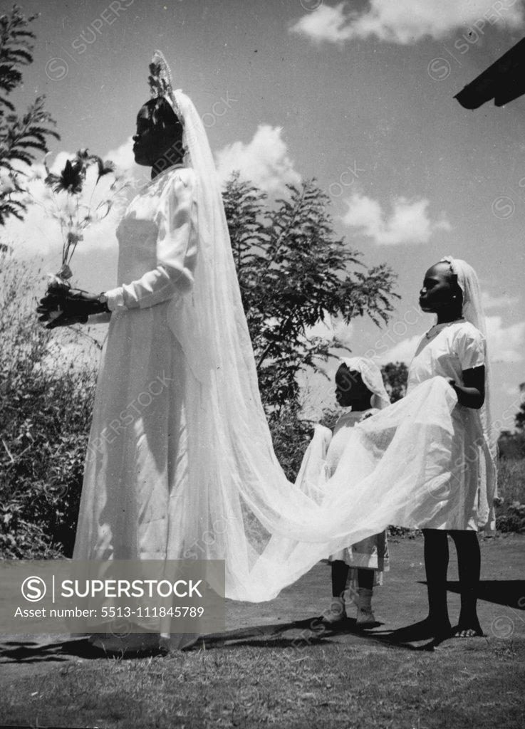 Stock Photo: 5513-111845789 Here Comes The Bride -- Women the world over delight in dressing up for the great day. This young Buganda bride with her two youthful attendants, is no exception. She is a member of one of the most advanced Uganda tribes who delight in following European customs and dress. February 12, 1954. (Photo by Paul Popper Ltd.).;Here Comes The Bride -- Women the world over delight in dressing up for the great day. This young Buganda bride with her two youthful attendants, is no exception. Sh