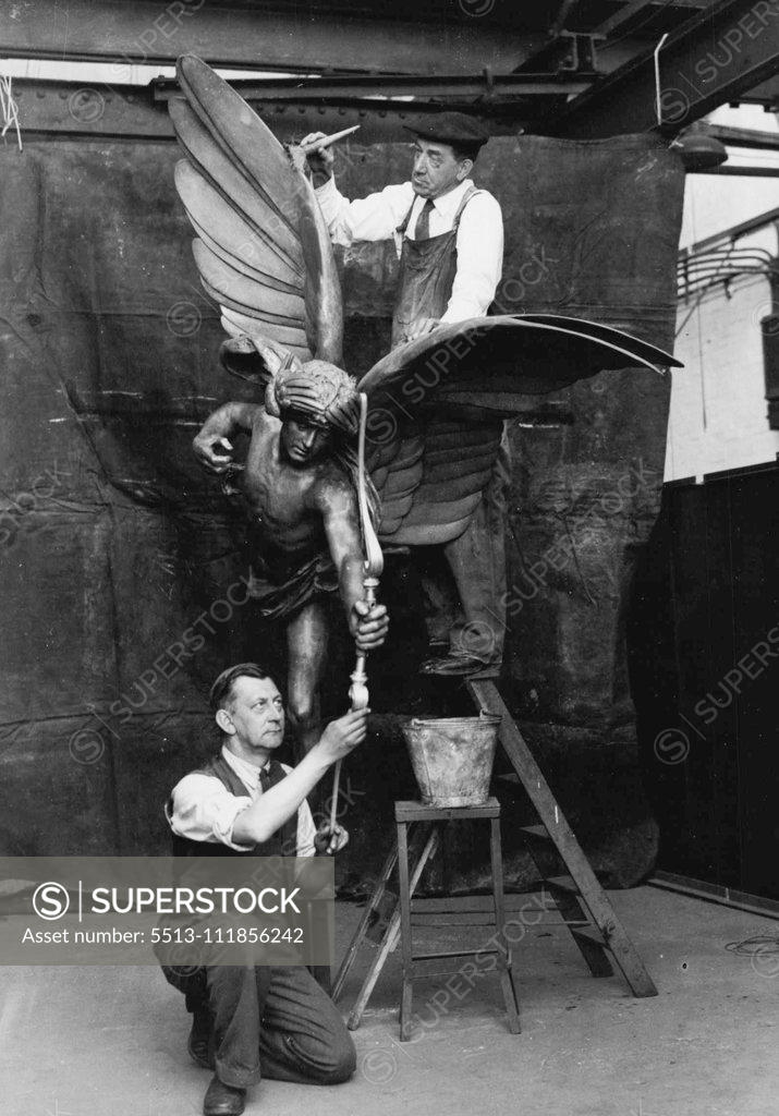 Stock Photo: 5513-111856242 Preparing Eros For Its Return To Piccadilly Circus -- Workman busy cleaning Eros in readiness for its return 'Home'. The statue of Eros is now being cleaned and repaired in preparation for its reinstatement in Piccadilly Circus, London. The revocation is being undertaken by the firm of J. Starkie Garner, Ltd., of Southfields, London. May 28, 1947.(Photo by Fox Photos).;Preparing Eros For Its Return To Piccadilly Circus -- Workman busy cleaning Eros in readiness for its return 'Home'. The statu