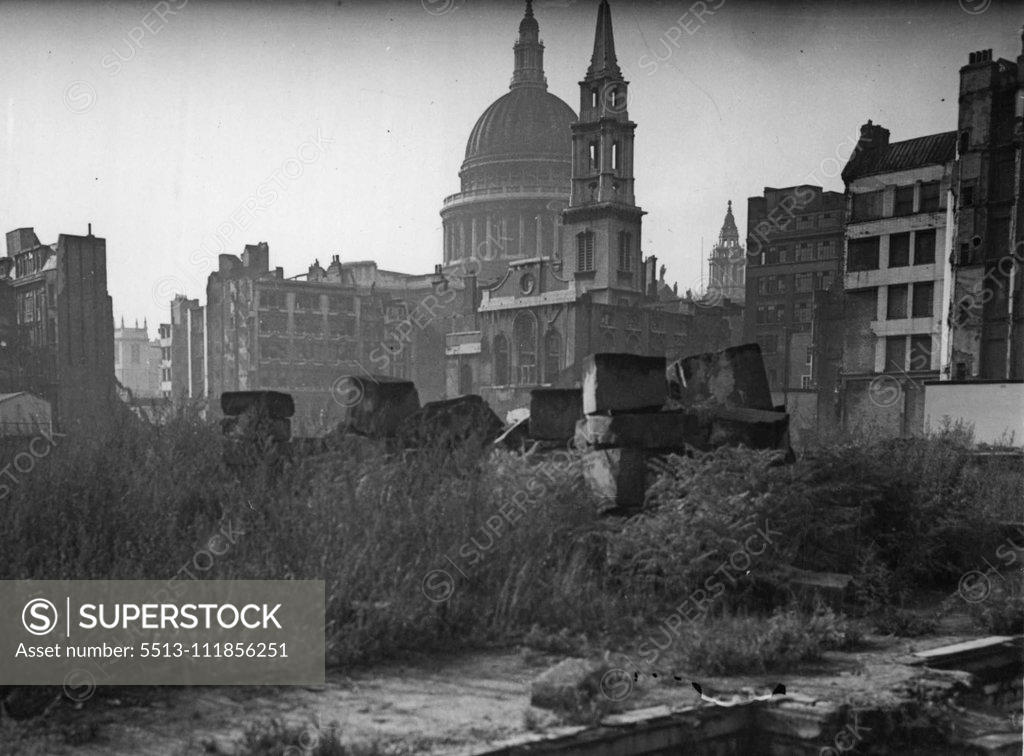 Stock Photo: 5513-111856251 A Wilderness in The Heart of The City of London - Great boulders lie among long grass and weeds where once tail building stood. A church, bombed in 1940, is just a shell. It is the Parich church of St. Vedast, built before 1249, and rebuilt by Sir. Christopher Wren in 1666. The scene - looking towards St. Paul's from Wood Street, is typical of many parts of our great City to-day, the bomb-scarred city for which the new Lord Mayor of London appealed in his Guildhall speech last night. "Let this r