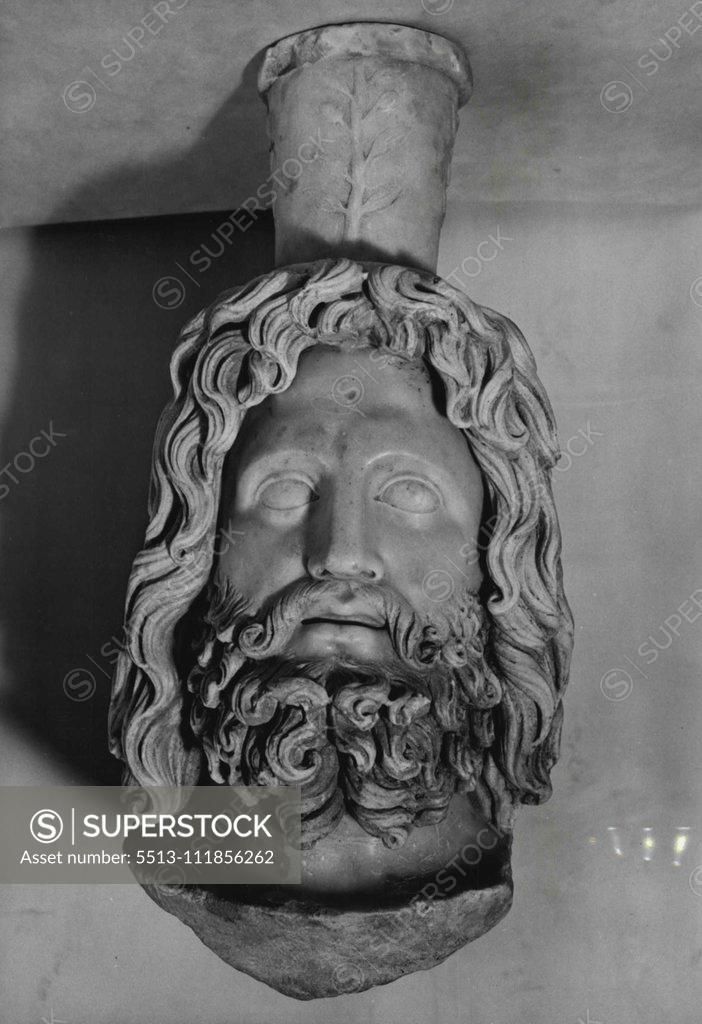 Stock Photo: 5513-111856262 Latest Discoveries From The Roman Temple -- The head of Jupiter-Serapis, which is perfectly preserved and is 14" high. He was the god of the underworld. Several more major finds were made on Monday at London Roman Temple, and nothing more exciting or more important artistically has ever been discovered in Britain, says Mr. G.F. Grimes, the Director of the London Museum, when he saw the treasures. Amongst a statuette of Hermes, the Greek god who conducted souls to the nether world, and a huge han