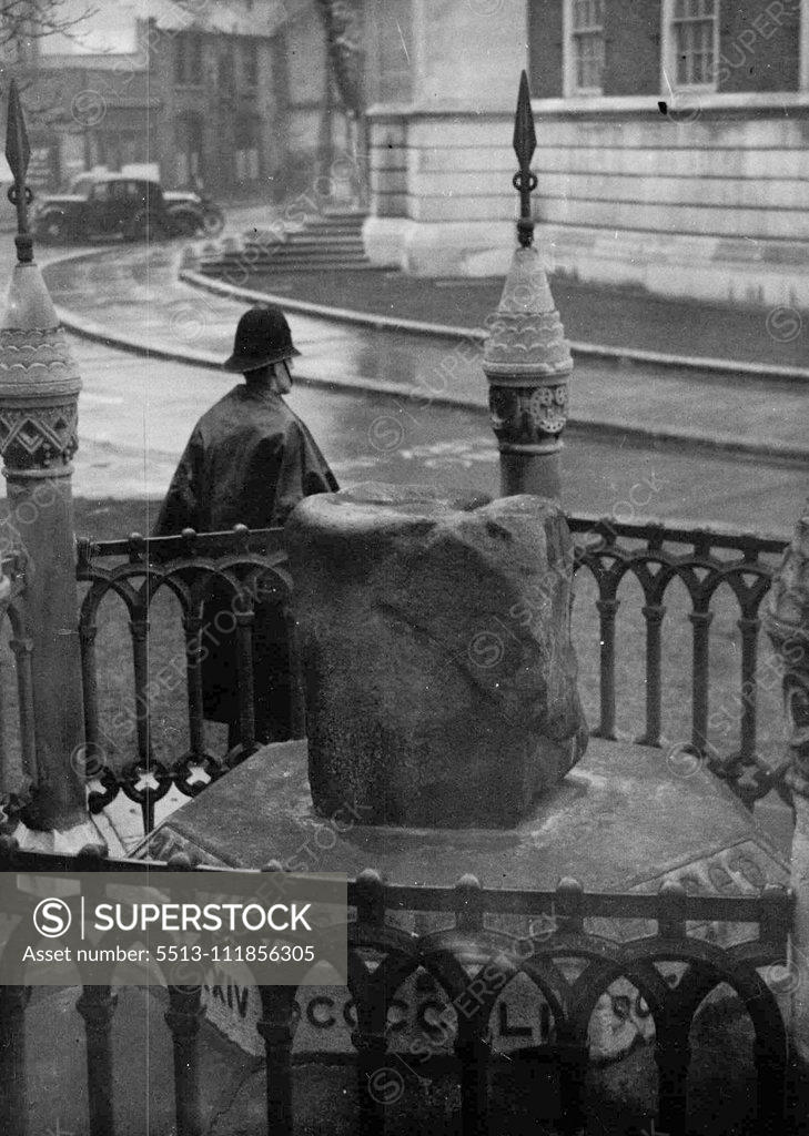 Stock Photo: 5513-111856305 He Guards Another Coronation Stone - A police constable here needs watch over the Saxon Coronation Stone (in foreground) at Kingston-on-Thames (near London). The policeman was put on guard after the scone coronation stone was stolen from Westminster Abbey on Christmas Day. Scottish nationalists threatened last March to remove the Saxon Coronation Stone and hold it as ransom against the return of the Abbey Stone, which, police believe, they have now stolen. December 28, 1950. (Photo by Associated