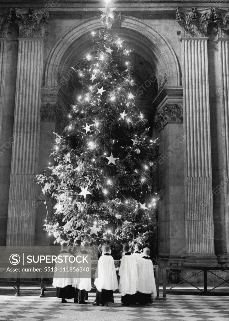 Stock Photo: 5513-111856340 A Royal Look For A Royal Tree Boys from the St. Paul's Cathedral Choir School seen admiring the Christmas tree on the Cathedral steps as they illuminations are tested this morning. The work of decorating, and illuminating the two 36ft. Royal Christmas trees at St. Paul's Cathedral is being completed today and from tomorrow, the trees will be illuminated each day and evening until January 6th. It Is an annual custom to erect two tress at St. Paul's, one on the stops of the Cathedral and on-9 insi
