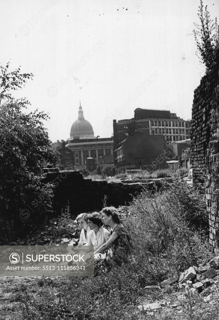 Stock Photo: 5513-111856341 A Lunchtime Haven In The City. A trio of City office girls find a cool, quiet haven, on a bombed site in Gresham Street within sight of St. Paul's Cathedral and just a stone's throw from the hot, noisy streets. Turning their backs on the City skyline, the three girls (left to right) Valerie Payne of Bromley, Lillian Weller of Eltham and Geraldine Turner of Wood Green, can enjoy their sandwiches and a rest on the cool grass in their own little bit of "country". July 14, 1955. (Photo by Fox Photos