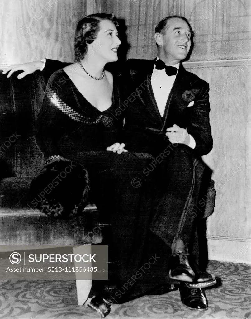 Early comers to the Wool Ball were Mr. and Mrs.Neil Ackland. She wore black wool jersey with gold sequin trimming. May 28, 1950.;Early comers to the Wool Ball were Mr. and Mrs.Neil Ackland. She wore black wool jersey with gold sequin trimming.