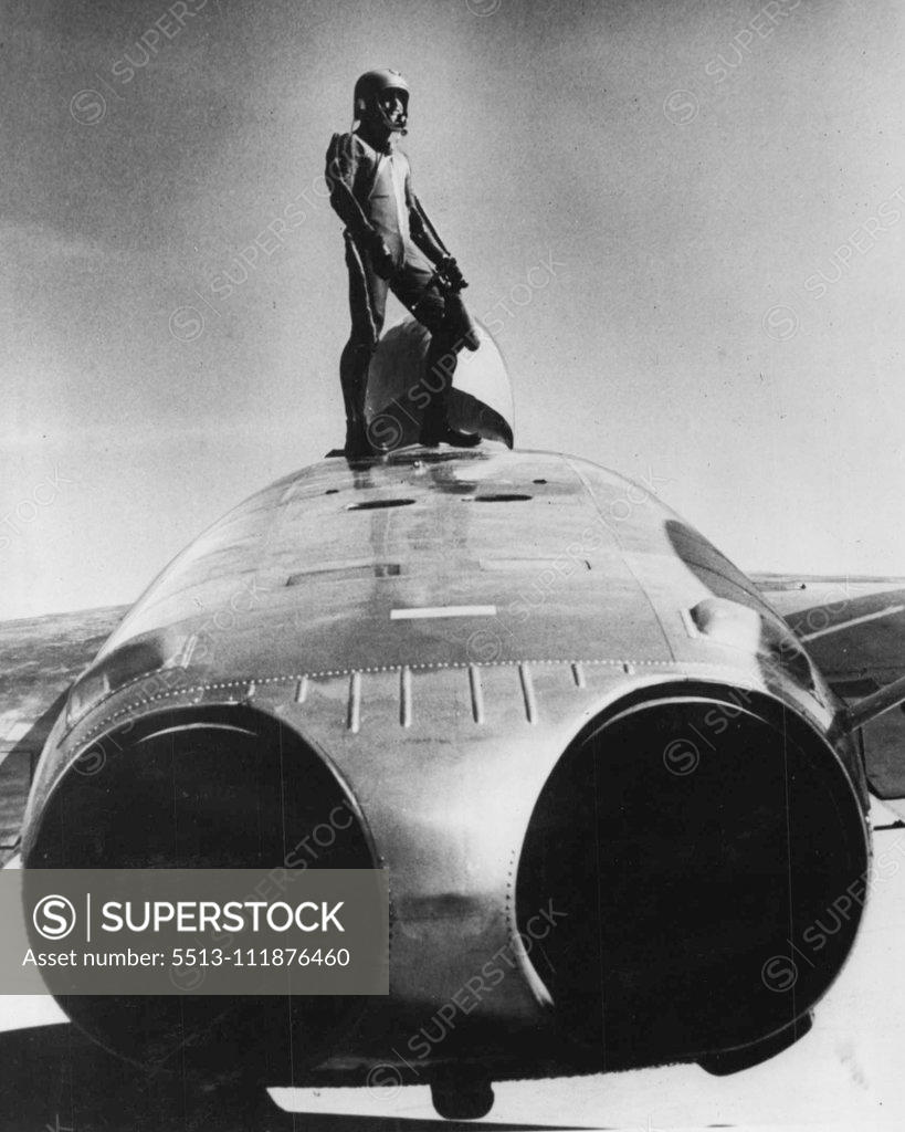 Stock Photo: 5513-111876460 Is This A Man From Mars -- On, Just A U.S. Navy Pilot climbing out of the F7U-3 cutlass jet fighter. The cutlass is the first U.S. fighter plane to carry its rockets in an aluminium fuselage pack. After the rockets have been fired, the pack can be reloaded and used again. In the past the plasticized cardboard wing pods were jettisoned after firing. Another feature of the cutlass is that the pilot is not blinded by the rocket's flaring exhaust during night firing because of the location of the 
