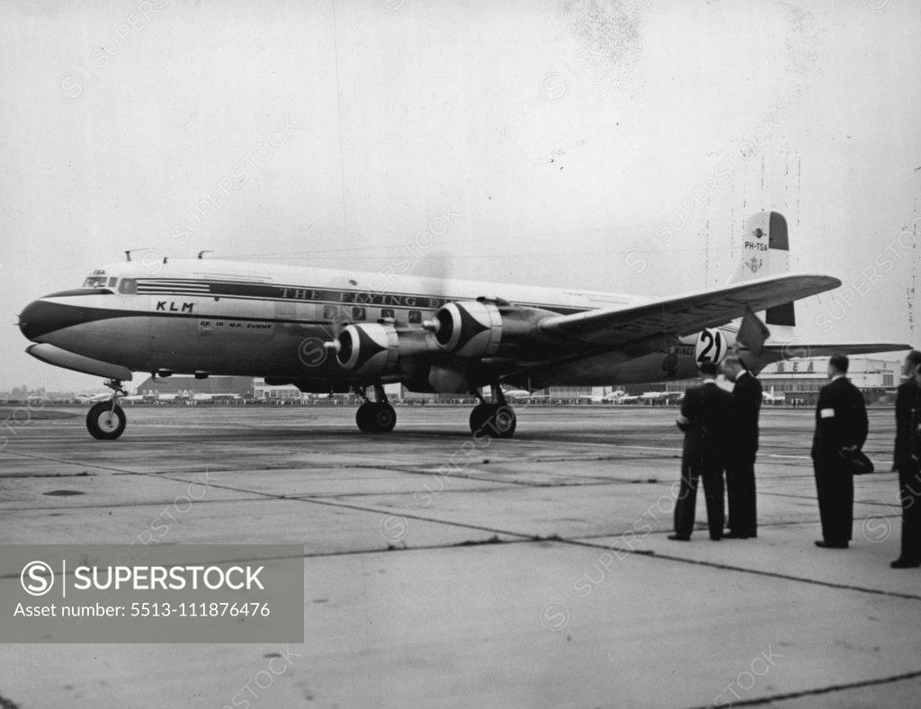 Stock Photo: 5513-111876476 12,000 Miles To Go -- The Duke of Gloucester holds the flag ready for the exact moment to send the Bea Viscount on its way. Planes competing in the 12,000 miles, London - New Zealand air race took off from London airport today. H.R.H. the duke of Gloucester was the official starter for the race. Before sending the planes off on their long flight, the duke spoke to the crews and inspected the planes. First plane to take off was the K.L.M. Liftmaster, competing in the transport section. October