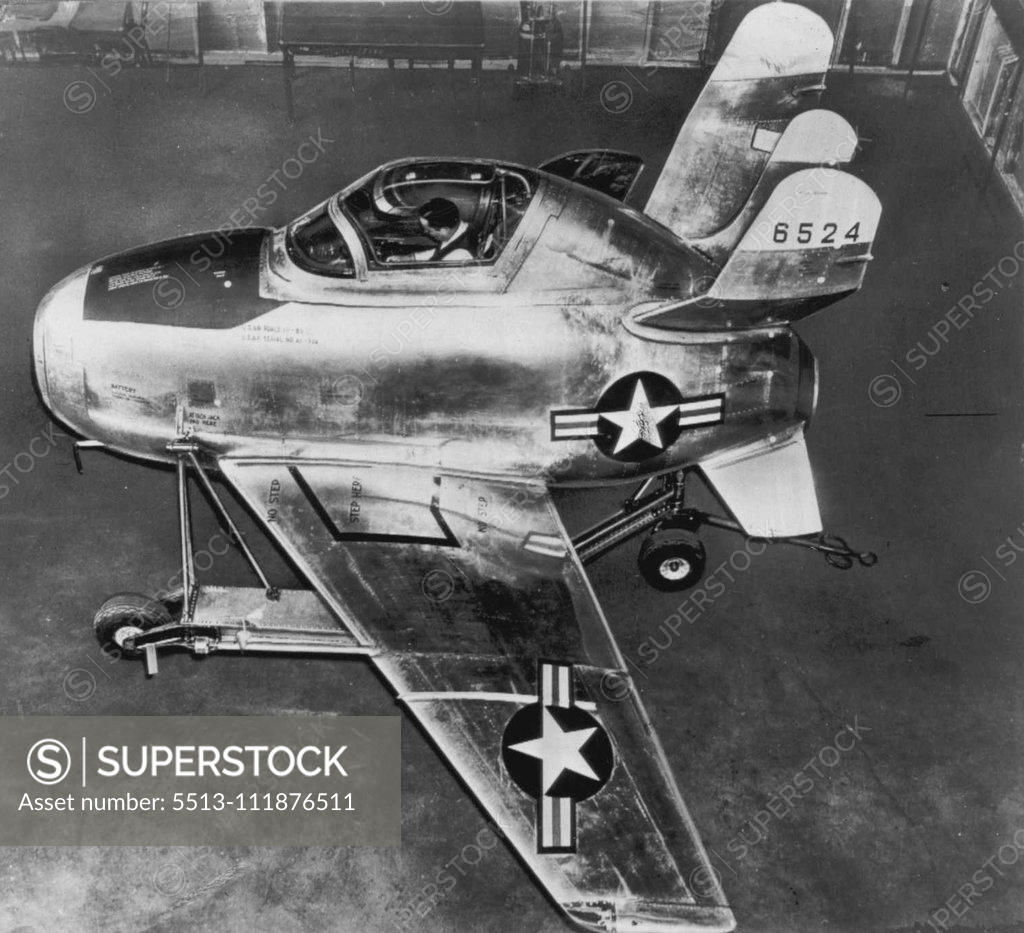 Stock Photo: 5513-111876511 'Parasite' Fighter Plane -- Mounted on a special dolly, the U.S. Air Force's new 'parasite' jet-powered fighter plane, the XF-85 (above) is ready for ground and wind tunnel tests. Plane has no landing gear and is designed to fit into the bomb bay of a B-36 from which all landings and takeoffs are made by means of a hooking mechanism. Craft has a wing span of 21 feet and is 15 feet long. Wings are folded back within the bomb bay. Odd tail assembly gives maximum flight stability and still permits 