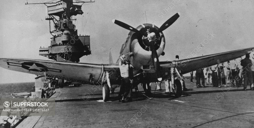Stock Photo: 5513-111876527 Navy dive/bomber prepared for mission against the Japanese in the Central Pacific on the flight deck of a Pacific Fleet aircraft carrier. March 17, 1944. (Photo by Official U.S. Navy Photograph). ;Navy dive/bomber prepared for mission against the Japanese in the Central Pacific on the flight deck of a Pacific Fleet aircraft carrier.