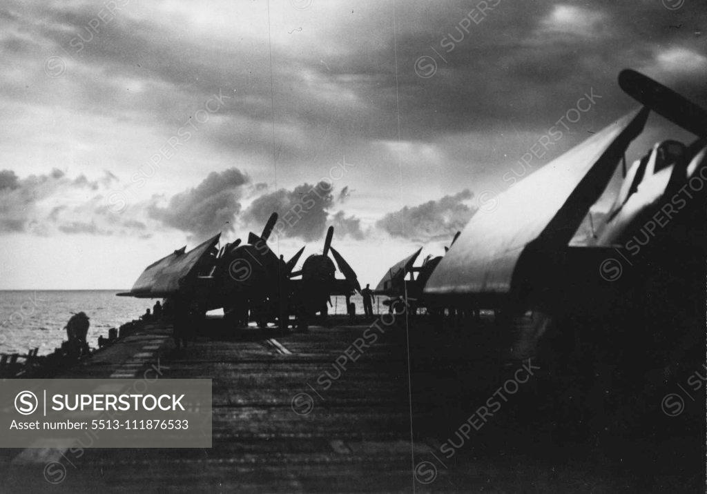 Stock Photo: 5513-111876533 Clouds and carrier-borne planes of the Pacific Fleet silhouetted against a sunset in the Central Pacific. March 30, 1944. (Photo by Official U.S. Navy Photograph).;Clouds and carrier-borne planes of the Pacific Fleet silhouetted against a sunset in the Central Pacific.