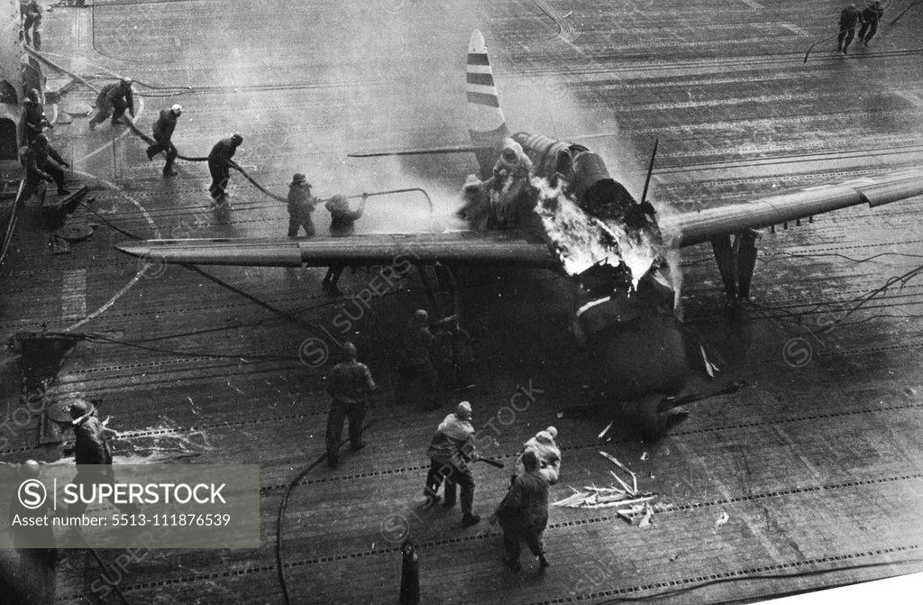 Stock Photo: 5513-111876539 U.S. Sailors Fight Flames -- Two fire fighters free the pilot from the cockpit of the blazing plane as additional crewmen approach to fight the fire. A crewman on the wing has ***** himself between the flyer and the flames, ***** the pilot with his own body as he lowers him ***** second man. The plane's gunner has already ***** through the protective spray spread in ***** right wing. The blaze resulted when the ***** Helldiver bomber failed to engage the ***** gear when it came aboard the U.S. *