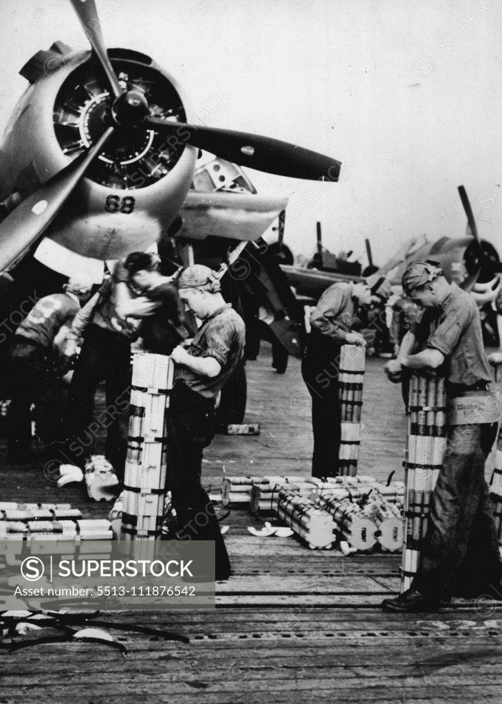 Stock Photo: 5513-111876542 U.S. Bombers ***** For Raid On Tarawa -- Sailors on an American aircraft carrier load incendiary bombs aboard U.S. Navy planes during a raid on Tarawa, Japanese base in the Gilbert Islands. The picture was taken between bombing missions. Planes from the carrier made repeated attacks on the enemy based during a two-day period, silencing many Japanese anti-aircraft batteries and destroying other installations. Long-range Army and Navy bombers also took part. November 29, 1943. (Photo by U.S. Offi