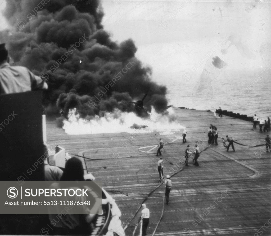 Stock Photo: 5513-111876548 Fire Crew Battles Flames Of Plane Burning On Carrier -- Kept at a distance by intense heat, fire fighting crew on a U.S. carrier battle flames that engulf Corsair F4U whose belly tank exploded when plane landed. May 21, 1945. (Photo by AP Wirephoto).;Fire Crew Battles Flames Of Plane Burning On Carrier -- Kept at a distance by intense heat, fire fighting crew on a U.S. carrier battle flames that engulf Corsair F4U whose belly tank exploded when plane landed.
