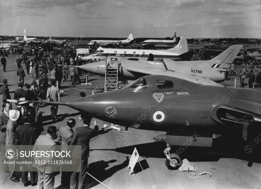 Stock Photo: 5513-111876568 "Planes With A Bite" - At The Air Show -- In the right background is a British Overseas Airways Corporation "Comet" - the world's first jet airliner. Aircraft that 'pack & punch' are on show at the society of British Aircraft Constructors' exhibition here. In the foreground is the Avro Type 707A, a delta-wing research aircraft, powered by one Rolls-Royce Derwent Turbo jet engine. September 1, 1952. (Photo by Planet News Ltd.).;"Planes With A Bite" - At The Air Show -- In the right background is 