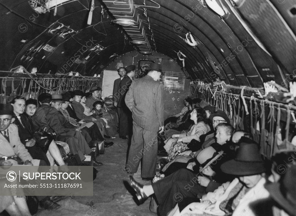 Stock Photo: 5513-111876591 ***** D.P.'s Are Flown From Berlin In Food-Lift Planes -- Some of the first batch of Polish Jews aboard a C-54 cargo plane as they left Tempelhof. For all of them, this was their first plane trip. Aboard flout-dusted American cargo planes - ***** from the food lift into Berlin - the first ***** 125 displaced Polish Jews flew form this ***** route to new homes in Canada and Palestine. ***** the vanguard of approximately 5,000 displaced ***** concentrated in Berlin in recent months for ***** from 