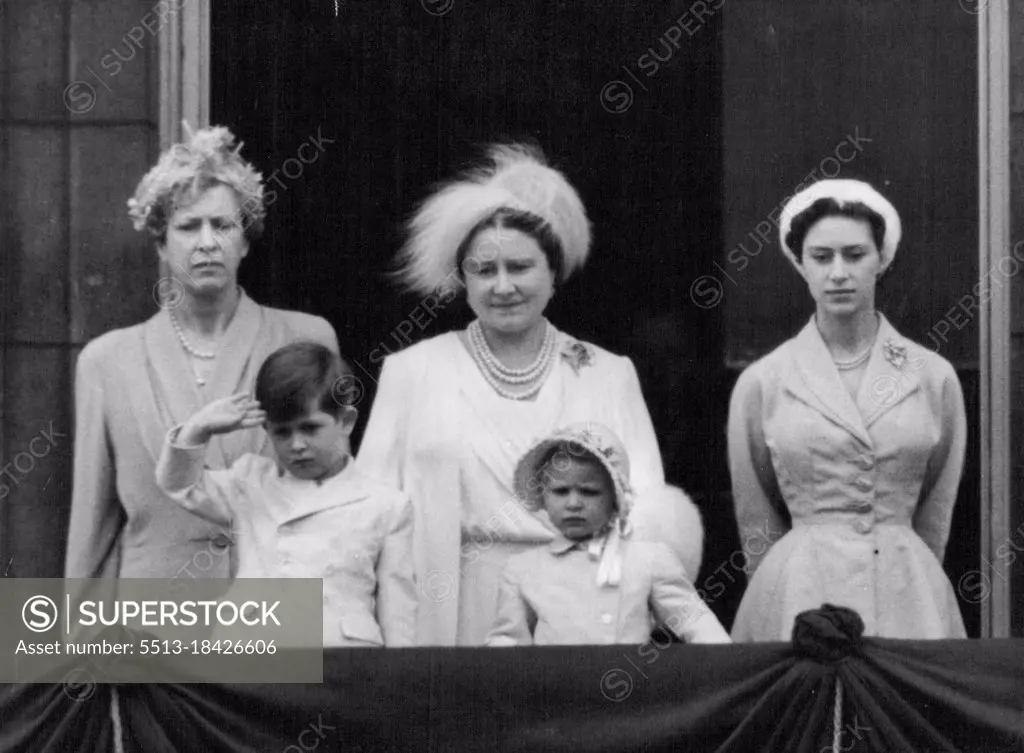 Prince Charles Keeps Time With His Mother - Prince Charles, standing on the balcony of Buckingham palace, follows his mother, the Queen and stands at the salute as the guards march past their Sovereign following the Trooping the Colour ceremony on horse guards parade, London, to-day (Thursday). Also on balcony are Princess Anne, Prince Charles sister: Queen Elizabeth, the Queen Mother : Princess Margaret : and the Princess Royal. The Queen took the salute at the gates of the Palace after leading her troops back from the parade ground. June 11, 1953. (Photo by Reuterphoto).