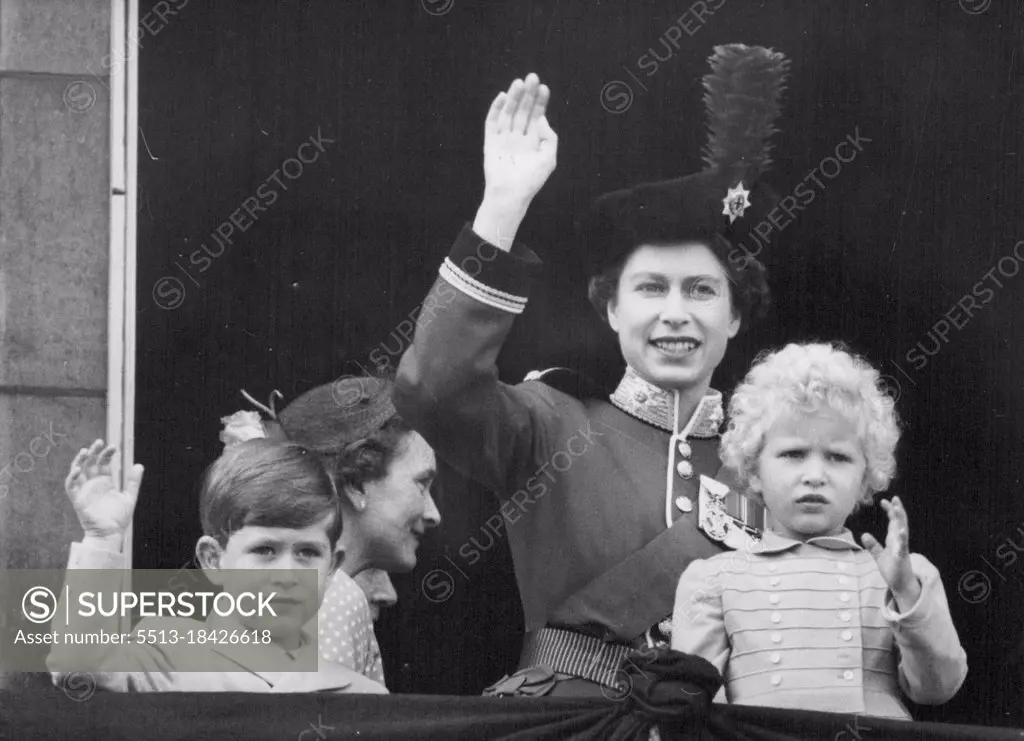 Queen And Children Wave From Balcony After 'Trooping'- The Queen, Prince Charles and Princess Anne wave from, the Buckingham palace balcony after the Queen's return to the palace balcony after the Queen's return to the palace following the traditional Trooping the Colour ceremony on Horse guards parade. From the balcony members of the Royal family the balcony members of the Royal family saw a fly-past of three squadrons of jet planes of the Royal Auxiliary air force - the first occasion on which the Auxiliary air force has been given the honour. The Queen wears her scarlet tunic and dark blue riding habit as Colonel-in-chief of the Coldstream guards. She was accompanied by the Duke of Edinburgh, who is 33 today, wearing the uniform of Colonel of the Welsh guards. The trooping ceremony and the fly-past following it mark the Queen's official birthday. June 10, 1954. (Photo by United Press Photo).
