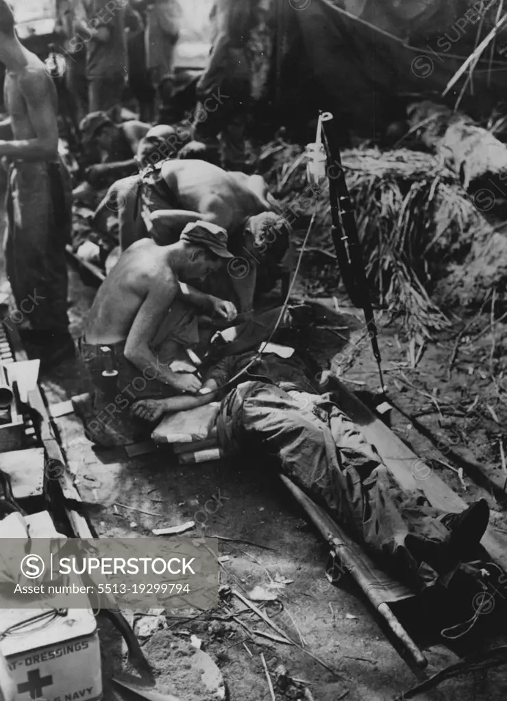 He Gave His .... Did You? -- A Marine, wounded in the assault on Guam, receives blood plasma to lessen and shock and replace blood lost when he was shot assaulting the beach. Transfusions similar to this saved countless lives. The Leathernecks lost blood but got some back because somebody gave theirs to the Red Cross. August 14, 1944. (Photo by Official U.S. Marine Corps Photo).