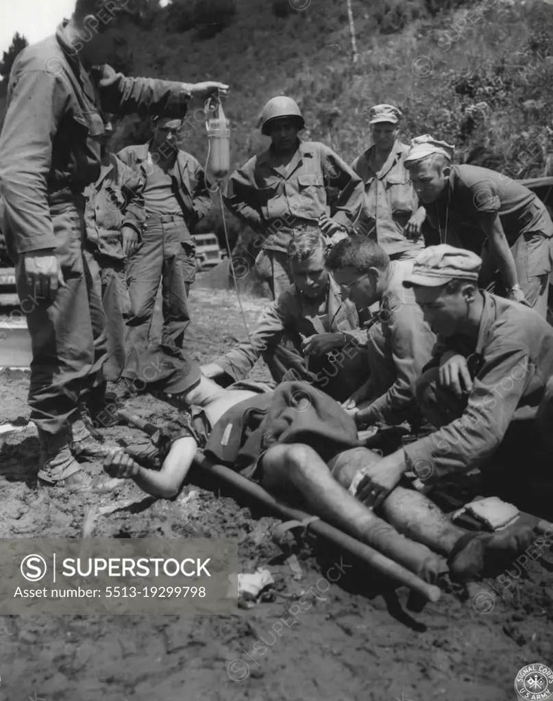 Aid For A Battle Casualty -- The war was still a grim ***** to this member of the 32nd Division a few day before the ***** of Japan's radio offer to capitulate. Blood plasma is being given at an aid station in Northern Luzon, where isolated pockets of stubborn Japs continued their futile struggle. August 13, 1945. (Photo by US Signal Crops Photo).