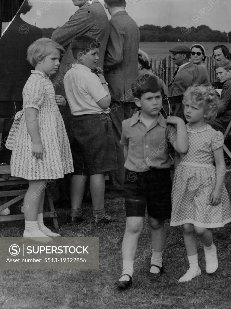 "Don't look now but there's somebody watching us."Princess Anne and Prince Charles chatter thoughtfully in a quiet moment at the Household Cavalry polo tournament last week at Windsor Great park.Girl on left seems to be comparing dresses. June 23, 1955.
