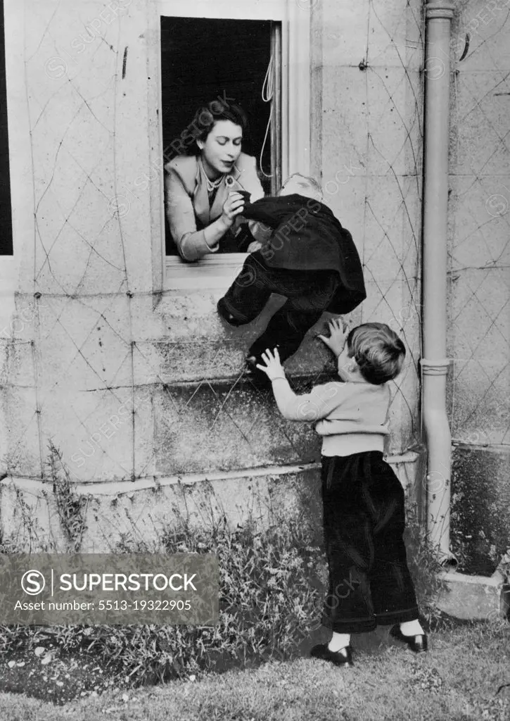 Help For Princess Anne
Princess Anne is assisted by the Queen and Prince Charles to climb in through one of the windows of Balmoral Castle. Prince Charles having climbed up once, jumped down again to help his little sister in her efforts to copy him. May 1, 1953. (Photo by Fox Photos).