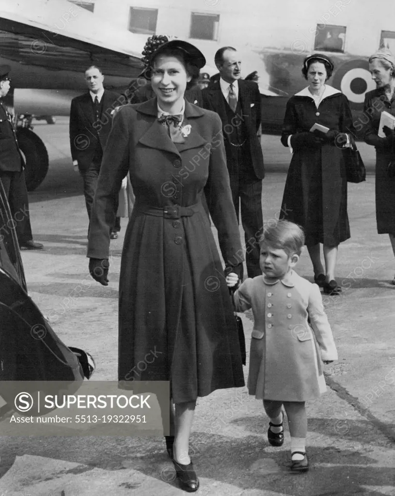 Prince Charles Welcome Home For Mother :Prince Charles holding the hand of his mother Princess Elizabeth, as they walks to the Royal car at London Airport to-day (Tuesday) when the Princess returned home after her visit to home with the Duke of Edinburgh.The Prince was there when the Viking aircraft of the King's Flight landed, and he entered the aircraft to greet his mother. April 24, 1951. (Photo by Reuterphoto).
