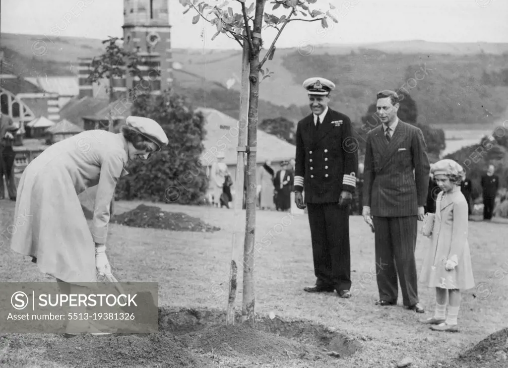 Royal Visit To Dartmouth -- Princess Elizabeth planting her tree in the College grounds, watched by the King and Princess Margaret Rose, at Dartmouth yesterday.The King and Queen and the Princess each planted a tree in the college grounds, during their visit to the Royal Naval College at Dartmouth yesterday. July 23, 1939. (Photo by Keystone).