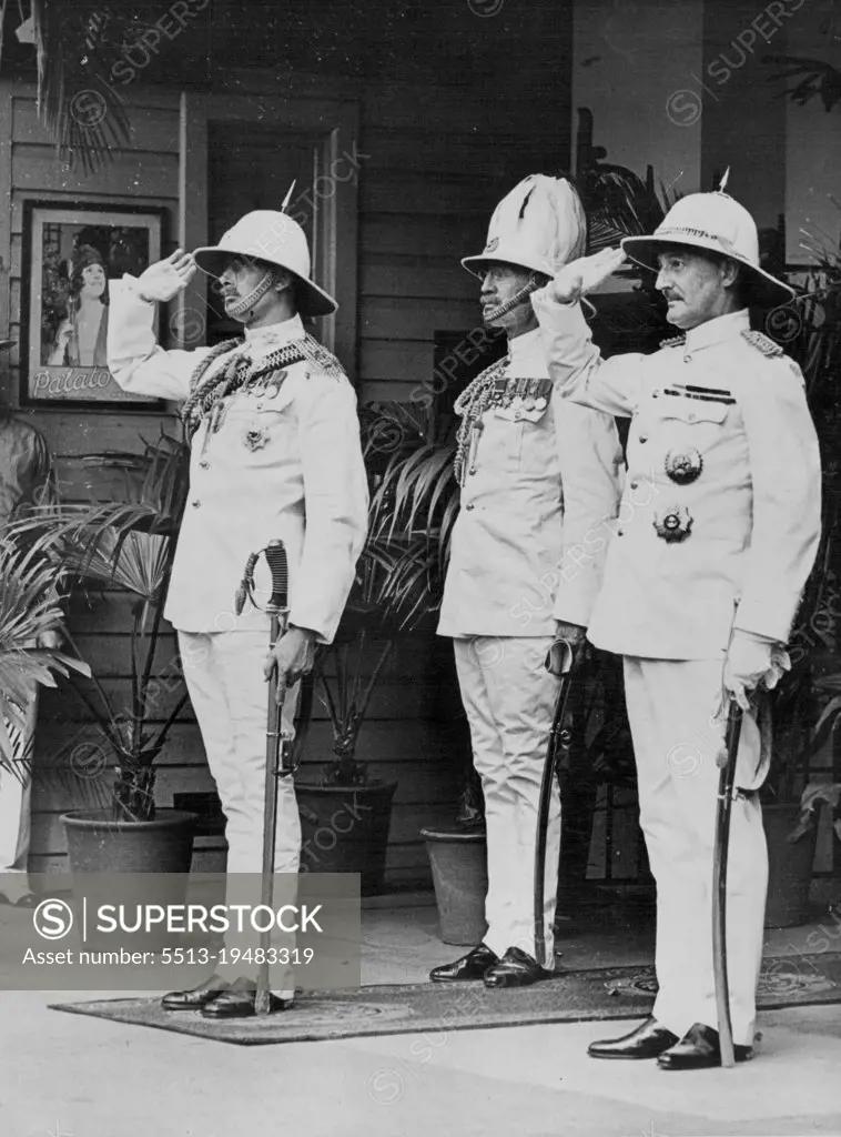 In Tropical Uniform -- His Royal Highness the Duke, the Governor (Sir Leslie Wilson) and the Duke's Chief of Staff at the salute during the playing of the National Anthem as they emergedfrom the Royal train at Brisbane. December 10, 1934.