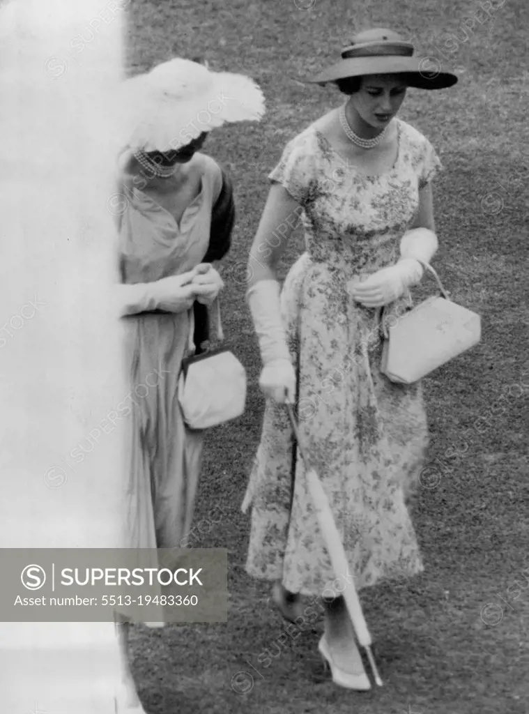 Princess Alexandra wears a flowered frock and carries a white handbag and neatly rolled matching umbrella at a garden ***** given by the ***** at Buckingham ***** Palace. July 22, 1954.