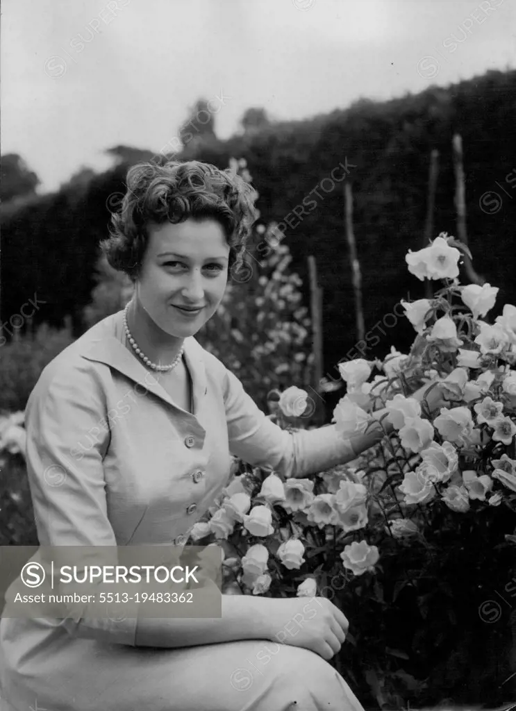 The Beauty in a Garden - Princess Alexandra has a charm to match the flowers in the lovely gardens at the Coppins. Like her late father, the Princess is a keen gardener and has ample scope in the fifteen acres surrounding her Iver home. These 'at home' pictures of the young and attractive Princess Alexandra and her equally attractive mother, the Duchess of Kent, were made at their country residence at the *****, Iver, Buckinghamshire, today (Friday). Apart from a brief finishing stay in Paris, Princess Alexandra has spent most of her 17½ years at the Coppins her mother's home since 1936. July 9, 1954. (Photo by Reuterphoto).