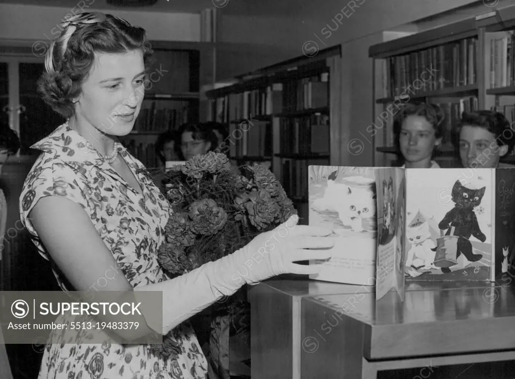 Royal Visitor - Princess Alexandra, daughter of the Duchess of Kent, seen looking at some French "Fairy Tale Books" in the Library of the new wing of the Royal foundation of Greycoat hospital, Westminister, today which the Princess opened. The hospital is now used as a girls school. July 18, 1955. (Photo by Paul Popper, Paul Popper Ltd.).