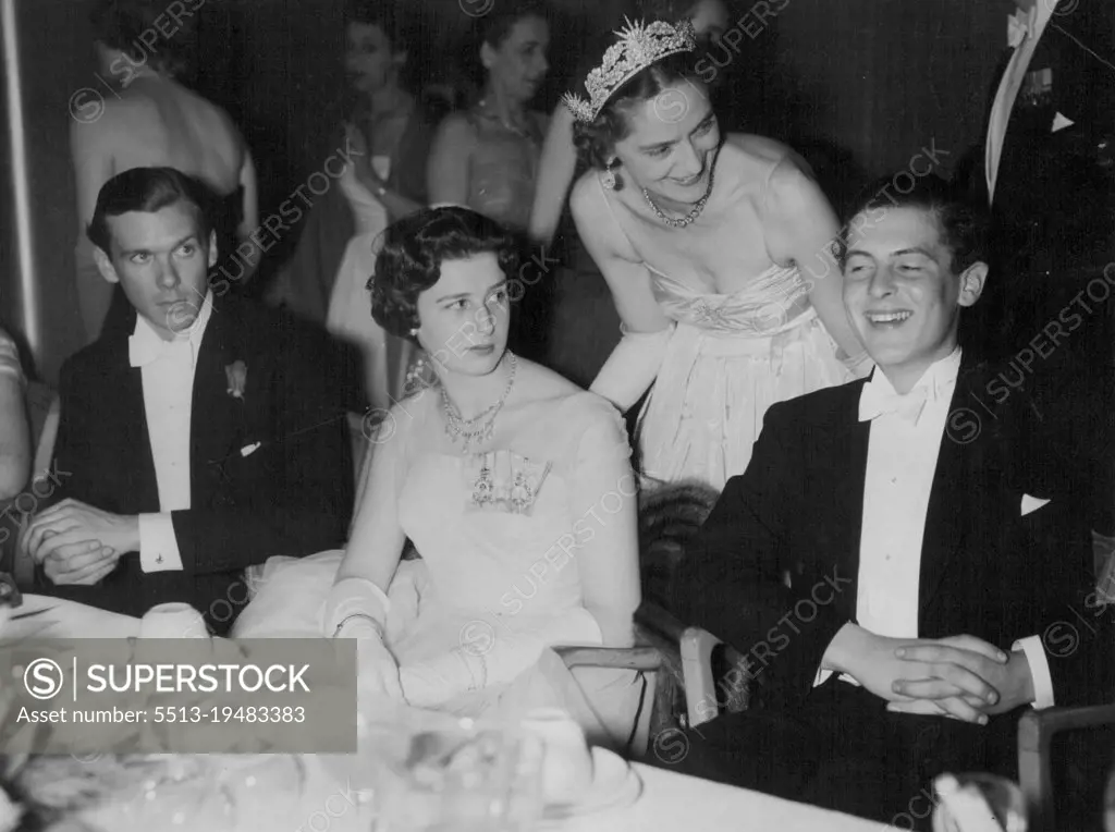 Lively Party - Sharing a joke at the Rose Ball at the Grosvenor House, London, last night are Mr. James Ogilvy and Lady Howard de Waldon. (Standing) Princess Alexandra in a ***** dress of white tulle is seated at left. May 5, 1955. (Photo by Evening Standard Picture).