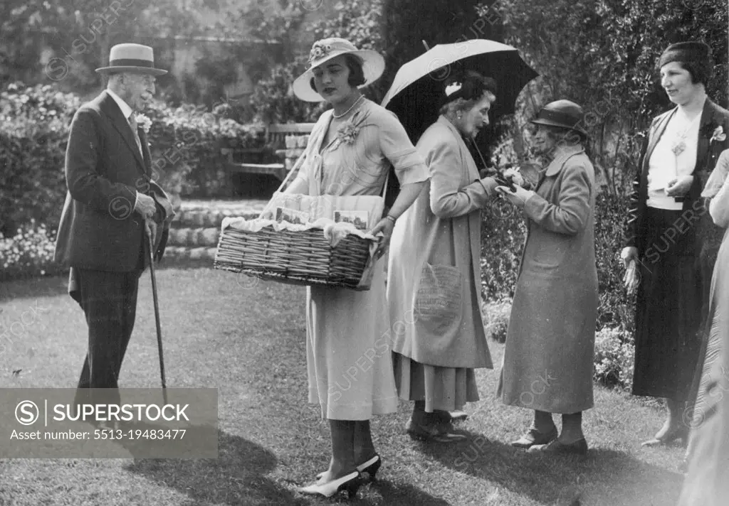 Princess Ingrid Sells Lavender Bags. -- Princess Ingrid selling buttonholes. The Duke is also seen and Princess Louise, talking to a visitor. The Duke of Connaught on Easter Sunday, opened to the public, the beautiful gardens of his vills "Les Bruyeres" at St. Jean, Cap Ferrat. Princess Ingrid accompanied by the Princess Louise, the Duke's sister, was busy selling bags of lavender in aid of the Queen Victoria Hospital at Mont Boron. May 29, 1933. (Photo by Central News).