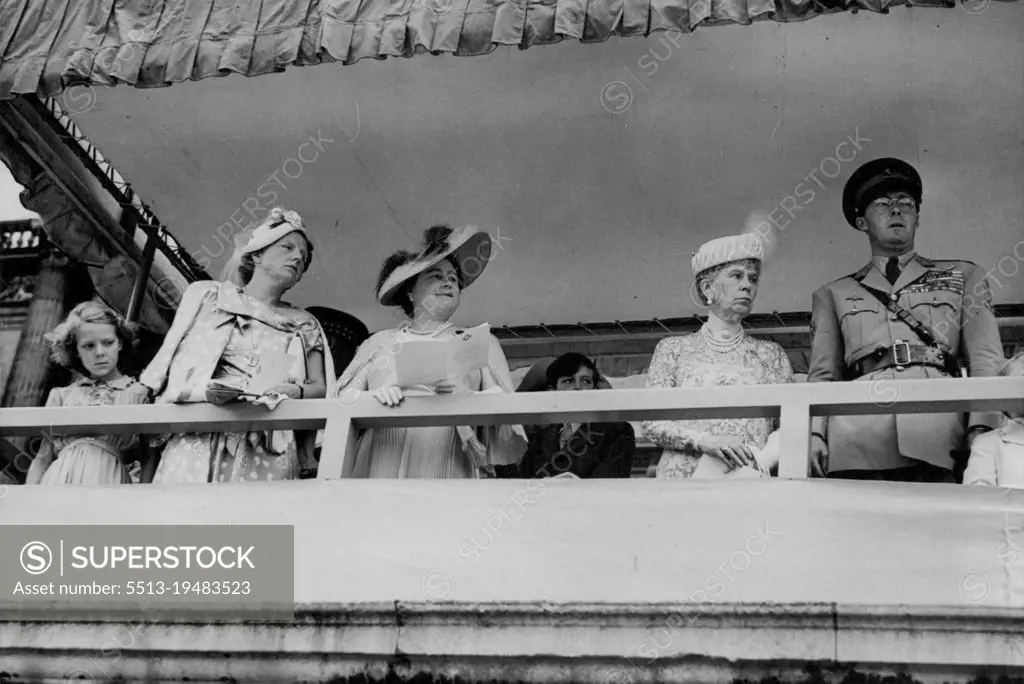 Queen Julian And Prince Bernhard See Colours Presented -- (Left to right) Princess Irene, Queen Juliana, Queen Elisabeth, Prince Bernhard watching the presentation of new colours to the Irish. Guards at Buckingham Palace today (Wednesday). The King, Colonel-in-Chief of the Irish Guards, presented the regiment with new colours at a ceremony at Buckingham Palace, London, today (Wednesday). The ceremony was watched by Queen Juliana of the Netherlands, Prince Bernhard, and Princess Irene, one of their daughters. July 27, 1949. (Photo by Reuterphoto).