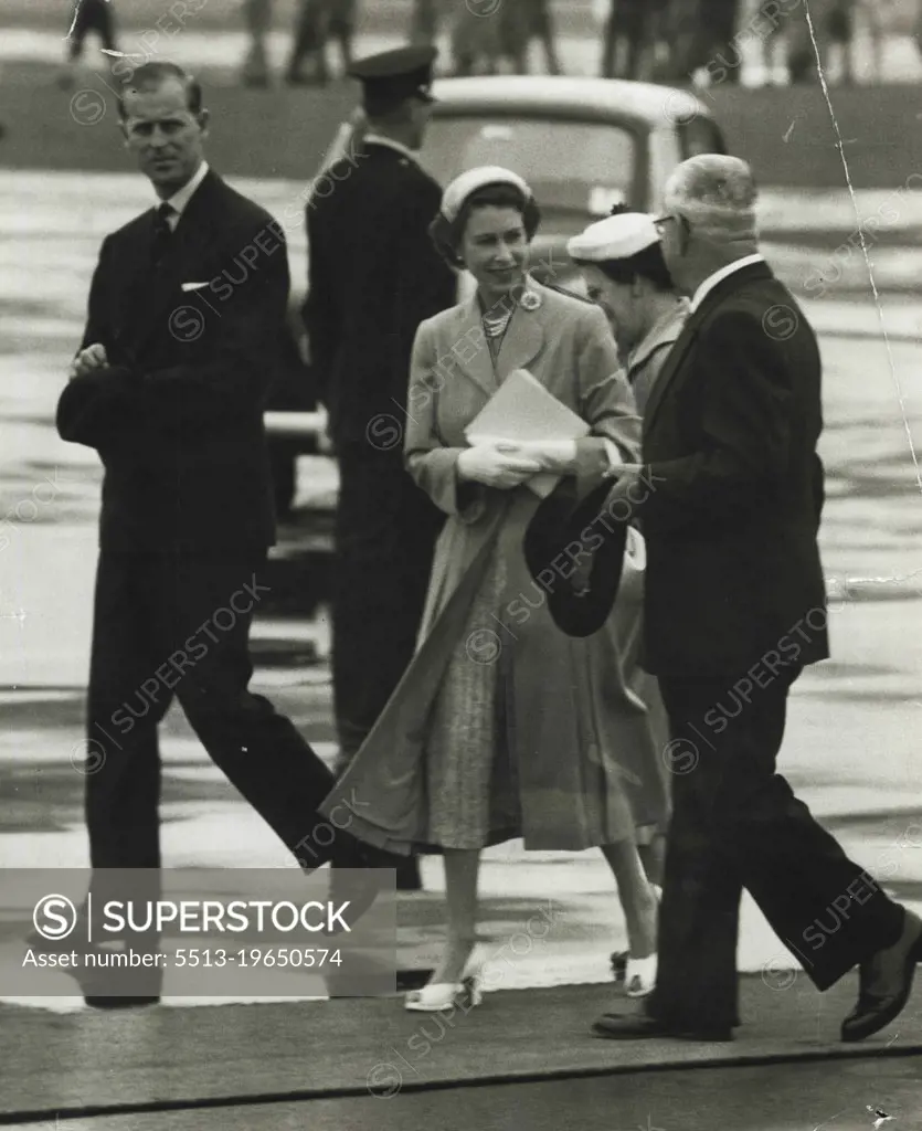Departure - The Queen chats with Deputy Premier Heffron as she walks across the tarmac at Mascot to the Royal plane for her flight to Bathurst. Mrs. Hefforn is partly obscured. February 12, 1954.