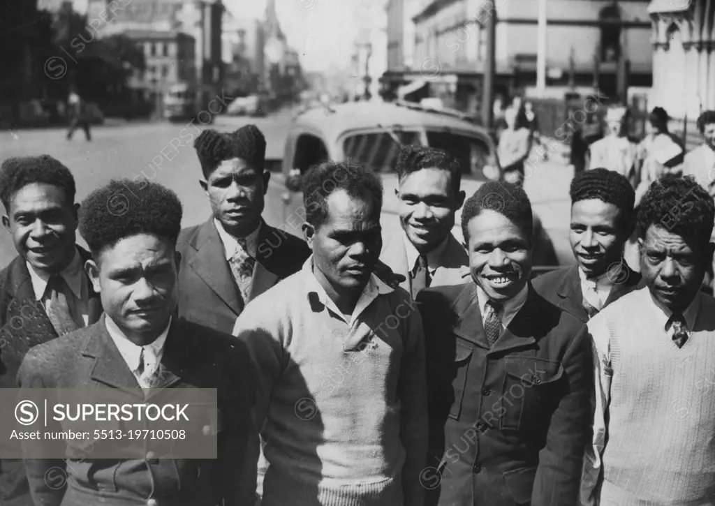 8 Papuan "Boys" See Town Today -- Eight Papuan "Boys", who arrived here by plane today, photographed in Elizabeth Street. They will form the crew of a lugger to be sailed to Port Moresby. October 15, 1947.