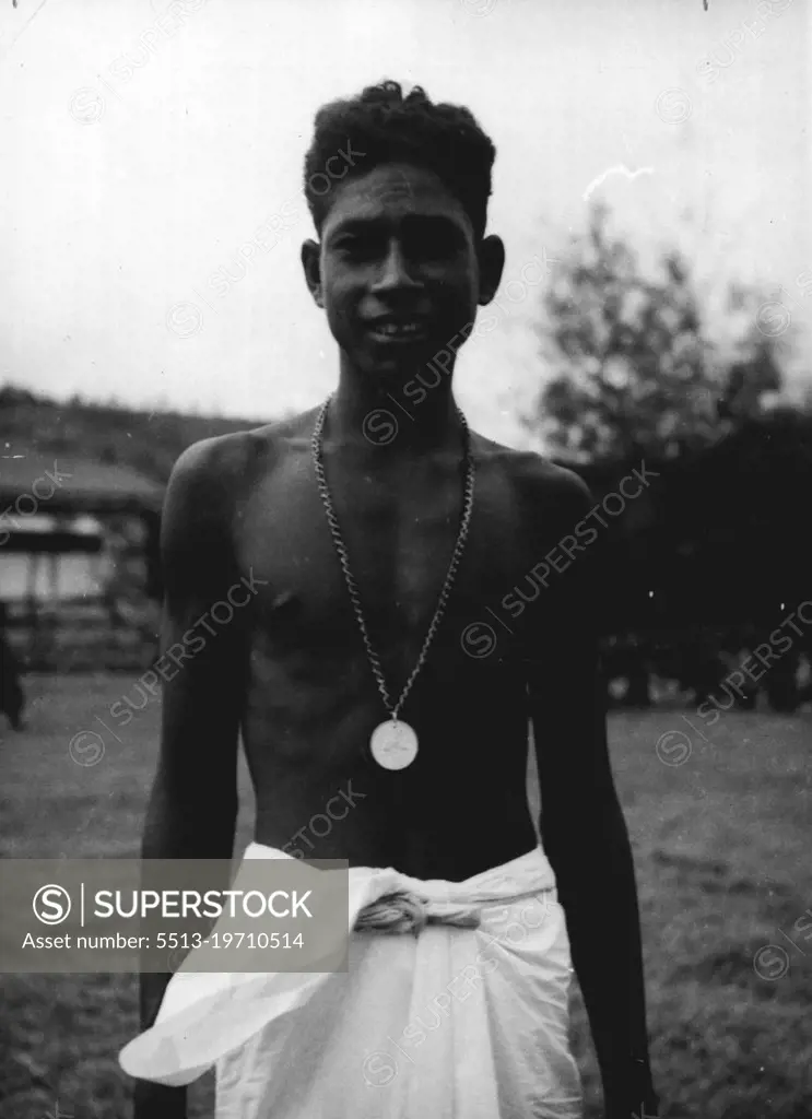 Paul Mea, a Papuan schoolboy with his Commonwealth Medal. Paul rescued two American soldiers from a flooded river in New Guinea. April 29, 1943.