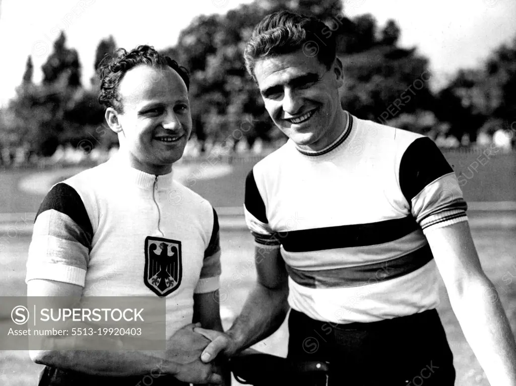 Great Britain V. Germany Professional Cycle Racing and Olympic Trials at Herne Hill:
Sid Patterson, the popular Australian Rider, being congratulated by German Sprint Champion, Warner Potzernheim after Patterson (right) had broken the half Mile unpaced flying start record by 8 of a second established by Reg Harris on the track in 1949.
Australian professional cyclist Sid Patterson is congratulated by German sprint champion Werner Potzernheim after Patterson has broken the half-mile unpaced flying start record by 8 sec at Herne Hill, London. May 17, 1952. (Photo by Paul Popper).