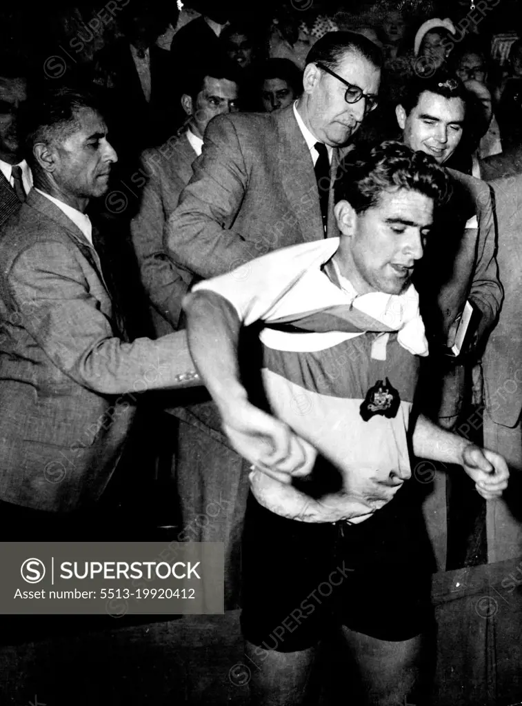 Australian cyclist Sid Patterson, dons the world champion's sweater after winning the world amateur pursuit title at Liege, Belgium. August 23, 1950.