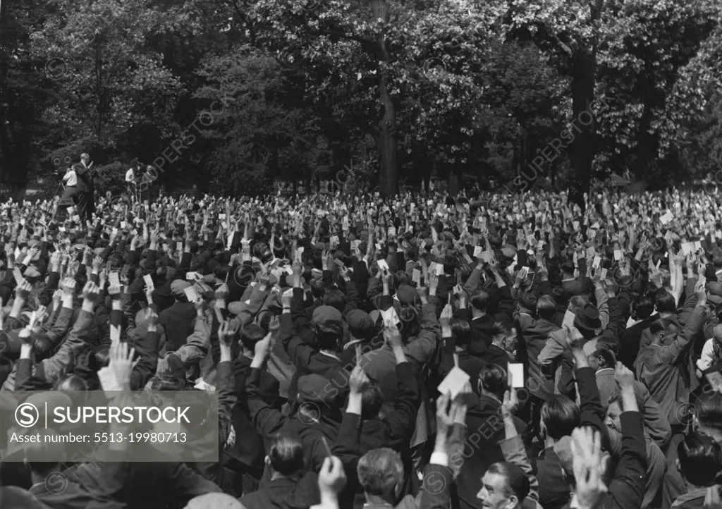 Back To Work On Monday -- The show of hands for "back to work" at the meeting today.By an overwhelming majority on a show of hands, London dockworkers, meeting this morning in Victoria Park, Bethnal Green, decided to return to work on Monday. July 22, 1949. (Photo by Fox Photos).