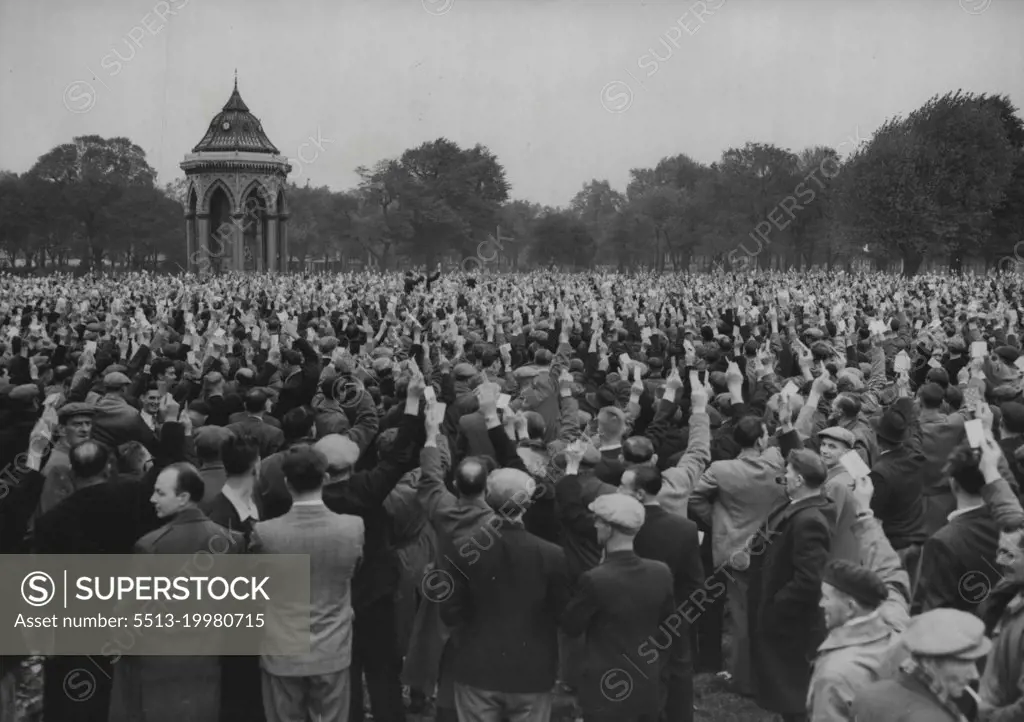 The Strike Goes On -- London Dockers at a meeting in Victoria Park, East London, today October 12, raise their hands to vote for the continuation of their nine-day-old strike. there are 26,000 men out. October 12, 1954. (Photo by Associated Press Photo).