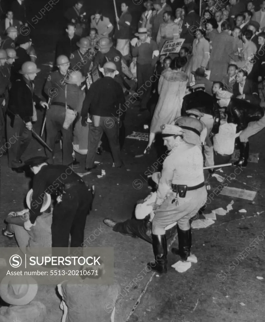 Down Pickets Again Get Heave - Ho - Deputy Sheriffs who yesterday had to drag sitting pickets away from the main entrance to Warner Bros., Studio do the job all over again this morning as strikers adopt same tactics. November 03, 1945. (Photo by AP Wirephoto).