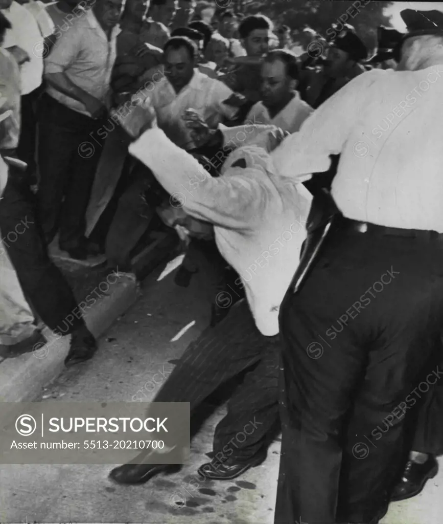 Police Charge Pickets -- Police are shown charging scattering pickets when fighting broke out at the Univis Lens plant this morning when non-striking workers were escorted into the plant. July 30, 1948. (Photo by AP Wirephoto).
