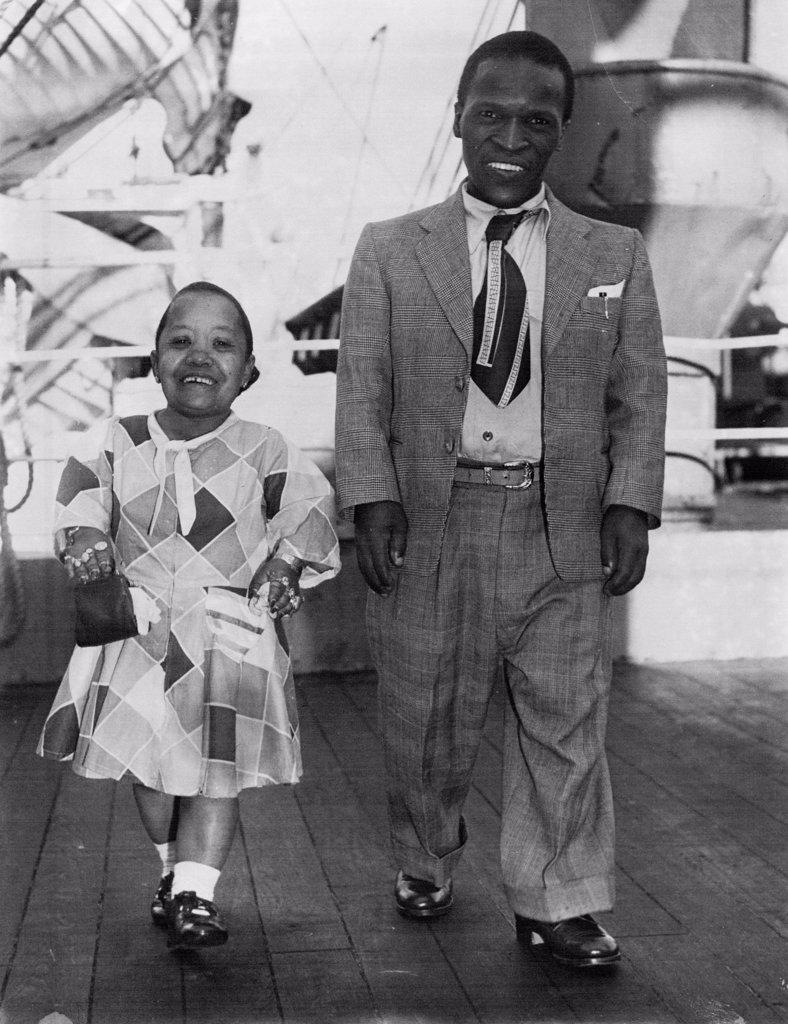 Aboard the Wanganella this morning where this Pygmies who are here far the Royal Easter show. "Ubangi Chilliwangi", 49 and Lomba Ishabalala 32 who has three wives & 19 children. March 27, 1952.