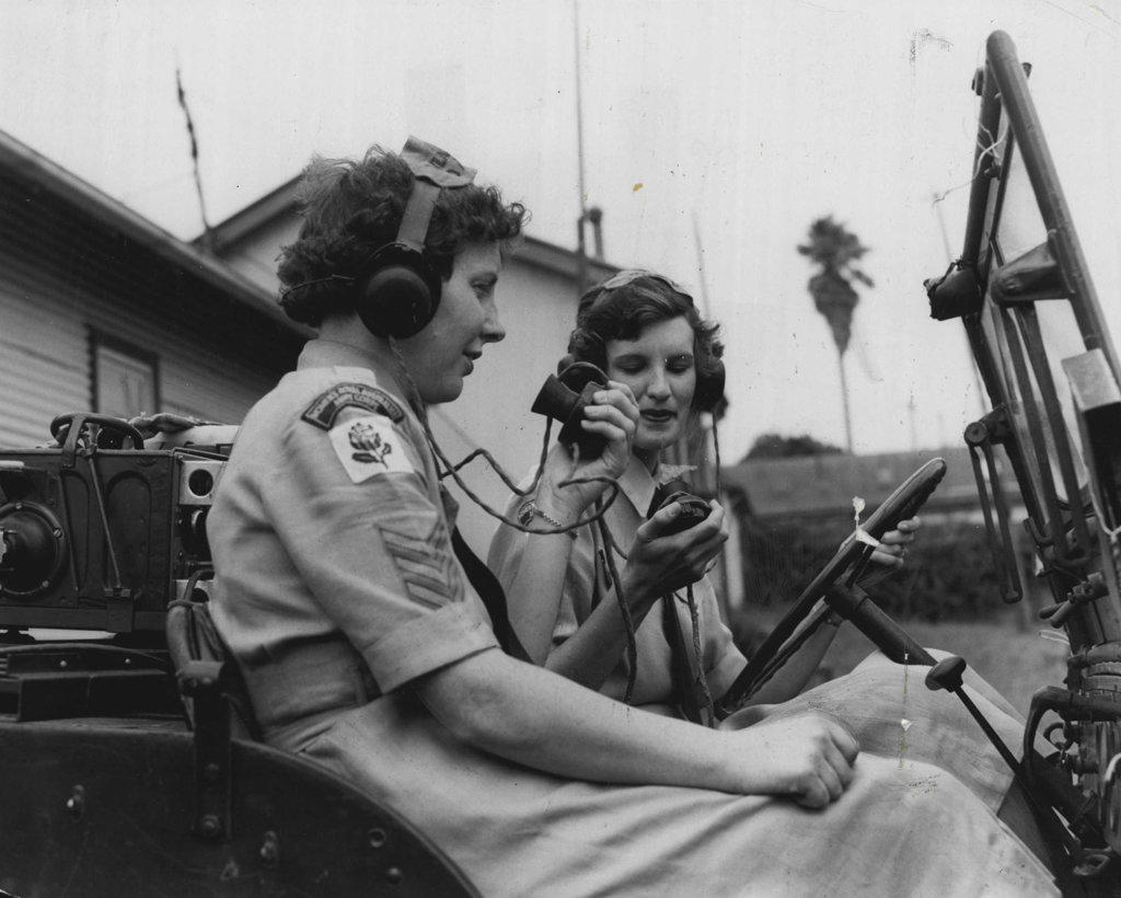 Sergeants Nora Fisher and Barbara McGovern in one of the jeeps used in map-reading and wireless-operating manoeuvre. March 13, 1955.