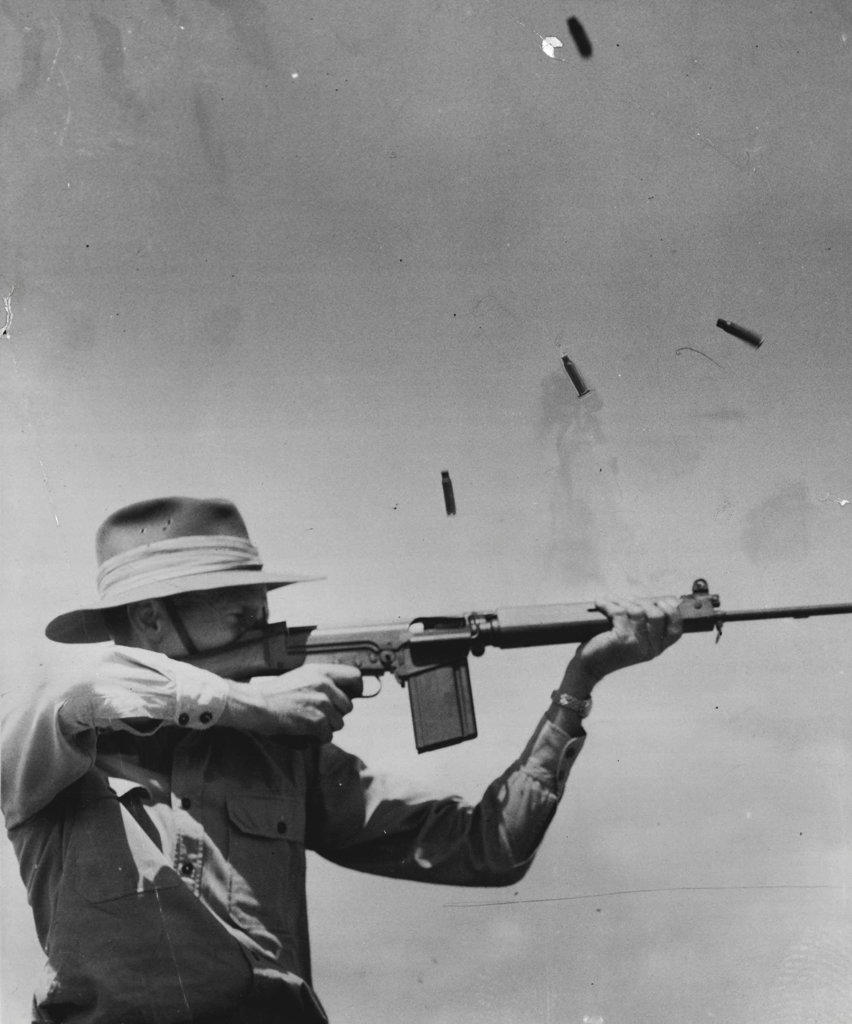 Deadly New Rifle. The Belgian FN.30 rapid-firing ***** will soon replace the Lee Enfield .303 as standard equipment for the Australian services. Split-second photography caught, in midair, the shellcases ejected from the new weapon demonstrated by Lt.-Col. J. E. M. Hall in Melbourne. February 9, 1955.