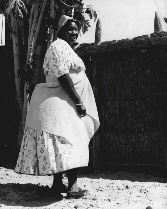 Barotse Women -- Leader of the Barotse women's fashions is the Chief's premier wife, called the 'Moyo' which means the Soul of the Nation. This photograph shows the 'Moyo' in a dress which gained world-wide popularity in the later part of the nineteenth century. It is the custom for the Chief to have wives from neighbouring tribes. The present ruler has twenty-five wives. June 23, 1952. (Photo by Nigel Watt, Camera Press).;Barotse Women -- Leader of the Barotse women's fashions is the Chief's pr