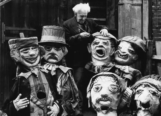 81-Year-old Barnum And Bailey Clown Still Makes Them Laugh -- 81-year-old Harry Russell photographed at work among some of his grotesque giant heads which he makes. In a white-washed shed in Norwood High Street, West Norwood, a youthful old man with a bushy mop of white hair continues a long life of making people laugh. 81-year-old Mr. Harry Russell was once a famous clown with Barnum and Bailey's circus, an claims to be its oldest survivor. He now spends his days making the giant papier mache 