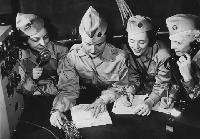 U.S. Woman Now Sentinels Of The Air -- Four members of the Civilian Air Patrol squadron study the Morse code for radio messages. November 2, 1942. (Photo by Interphoto News Pictures, Inc.).