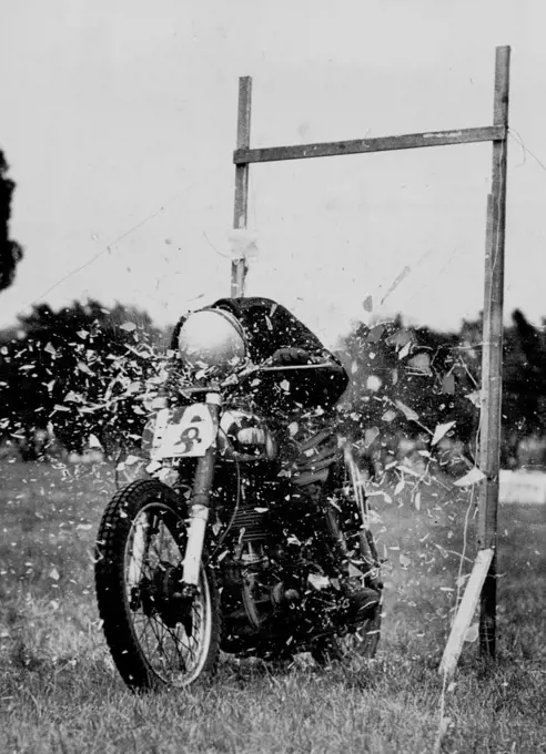 "Through a Glass Smartly" at the Motor Cycle - Pane-full to watch and considerably risky is this method of breaking plate glass demonstrated by Dave "Buster" Brister at the ***** Motor Cycle Club's gymkhana at the *****. "It outs down window cleaning bills" ***** who is "in a glass by himself" at this ***** (At Bexley). May 18, 1950.